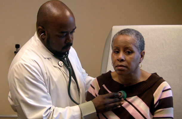 Sharron Moore, right, is examined by Dr. Patrick Antoine at the Southside Medical Center in Atlanta March 4, 2009. More than a third of Medicaid expenditures are devoted to long-term care services—at home and in the community as well as in nursing homes. (AP/Johnny Clark)