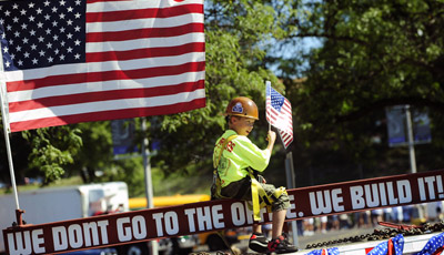 Hunter Ribarchak, 7, rides on the Iron Workers of America's float during the September 1, 2008 Labor Day parade in Pittsburgh, PA. (AP/John Heller)