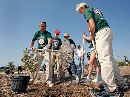 AmeriCorps volunteers and community partners plant trees at historic Virginia Key Beach Park in Miami on May 18, 2008. The number of applicants for AmeriCorps programs and volunteer trainings have doubled or tripled over previous years. (AP/EcoMedia, David Adame)