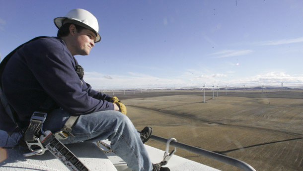 Seth Stanfield, wind plant supervisor, looks over the landscape from the top of a wind turbine January 7, 2008, at the PPM Energy wind farm, in Wasco, OR. The Waxman-Markey bill's call for increased production of renewable energy could translate into more clean-energy jobs. (AP/Rick Bowmer)