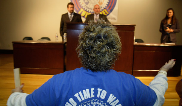 A worker speaks to a union negotiator at a meeting. (AP/Ted S. Warren)