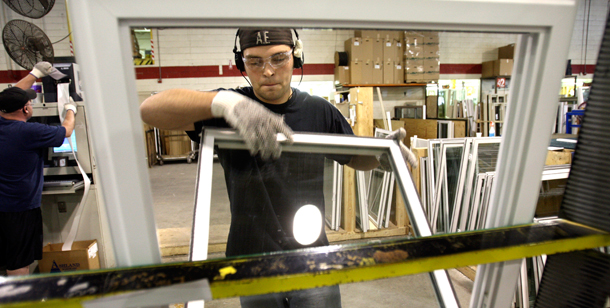 A worker assembles a more energy efficient window. The Green Bank could give a boost to programs like this that help weatherize homes. (AP/Carlos Osorio)