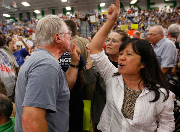 Supporters for and against health care reform shout at each other at a town hall style meeting in Vermont.  (AP/Charles Dharapak)