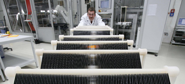 A technical manager checks solar cells in the ErSol Solar Energy AG in Erfurt, Germany, which manufacturers and distributes solar photovoltaic products. Germany is a global frontrunner in the clean-energy transformation and its success is due to strong government financial support. The United States needs to keep up with its competitors who are seizing the clean-energy opportunity. (AP/Jens Meyer)