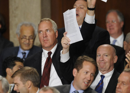 Republican House members hold up copies of health care bills as President Barack Obama delivers a speech on health care to a joint session of Congress, September 9, 2009, in Washington. (AP/Susan Walsh)