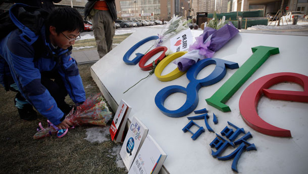 A Chinese Google user presents flowers in front of Google sign outside Google China headquarters building in Beijing on January 15, 2010. Google's recent announcement that it may pull out of China is the most immediate test of whether the U.S.-China relationship has actually become the "mature" one President Barack Obama and Secretary of State Hillary Clinton assert it is. (AP/Vincent Thian)