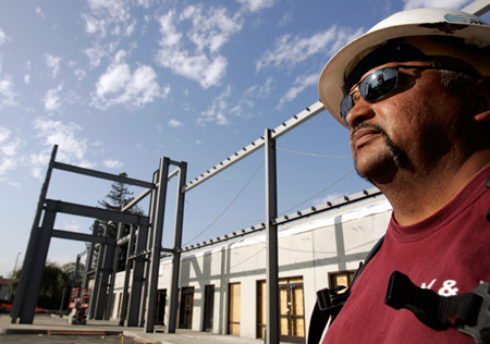 A worker watches over a building construction site. DOL will never have enough inspectors to scrutinize every workplace, but good data can help. (AP/Paul Sakuma)