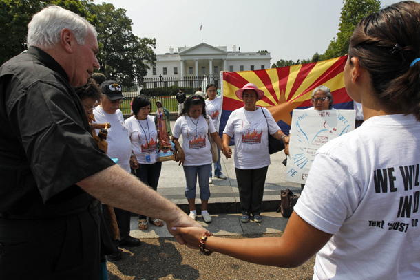 Hispanic community members hold hands in prayer to protest against SB1070, Arizona's immigration law, during a vigil in front of the White House. Many of the proposals in the Republicans' new "Pledge to America" would harm minority communities.
<br /> (AP/Alex Brandon)