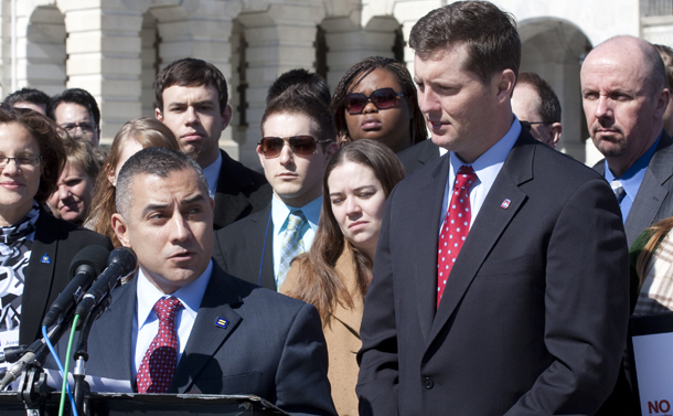 Former Staff Sgt. Eric Alva, who was forced out because of "Don't Ask, Don't Tell," speaks as Rep. Patrick Murphy (D-PA) listens at a rally on Capitol Hill. A growing body of research, expert opinion, and the experiences of U.S. allies show that gay men and women can serve openly without jeopardizing military readiness or effectiveness.
(AP/Harry Hamburg)