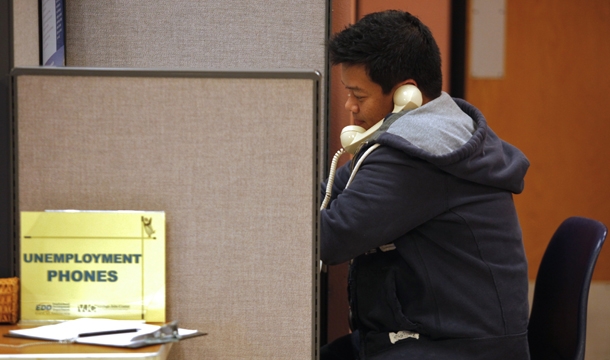 Unemployed financial worker Jonathan Velazquez phones in to get State of California's Employment Development Department, EDD unemployment benefits at the Verdugo Job Center. (AP/Damian Dovarganes)