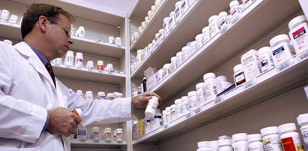 A pharmacist prepares a prescription at the Complete Care Pharmacy in Springfield, Illinois. The Affordable Care Act establishes a new income threshold  for the Medicare Part D prescription drug program. That means wealthier  seniors on Medicare will pay a higher premium for their medications. (AP/Seth Perlman)