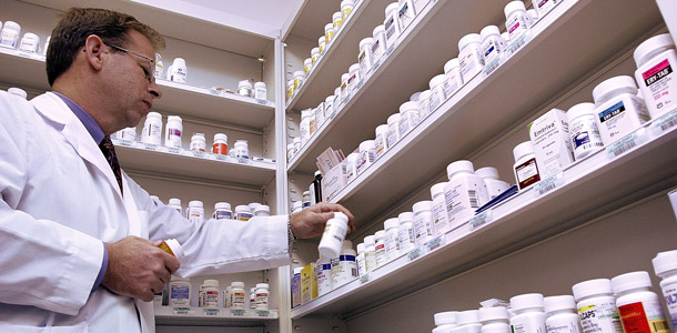 A pharmacist prepares a prescription at the Complete Care Pharmacy in Springfield, Illinois. The Affordable Care Act establishes a new income threshold for the Medicare Part D prescription drug program. That means wealthier seniors on Medicare will pay a higher premium for their medications. (AP/Seth Perlman)