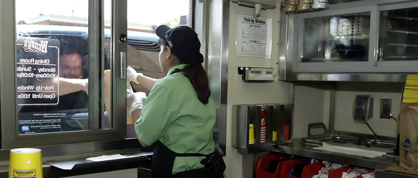 A Wendy's employee serves a drive thru customer. Legislators in Illinois, Maryland, California, Maine, and Massachusetts have introduced bills to raise their state minimum wages. There is a growing consensus among economists and academics that raising the minimum wage does not kill jobs even during periods of recession. (AP/Jay LaPrete)