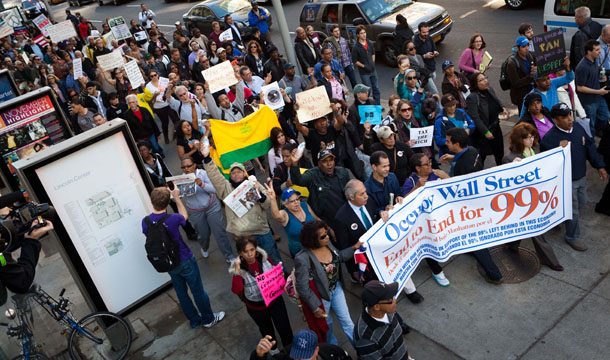 Demonstrators affiliated with the Occupy Wall Street protests pass through the Upper West Side during an 11-mile march from uptown Manhattan to Zuccotti Park, Monday, November 7, 2011, in New York. (AP/John Minchillo)