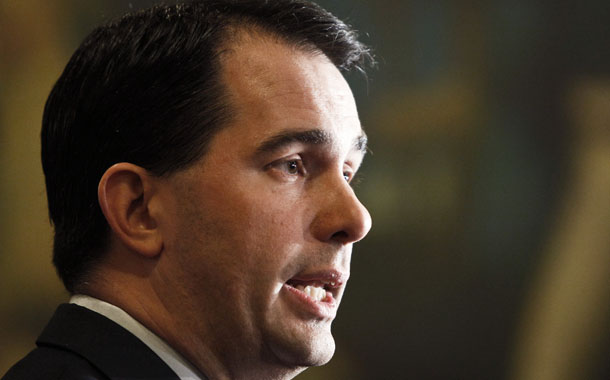 Gov. Scott Walker (R-WI) talks to the media at the State Capitol in Madison, Wisconsin. In March of last year, he signed an antiunion bill that stripped public-sector workers of collective bargaining rights.  (AP/Andy Manis)