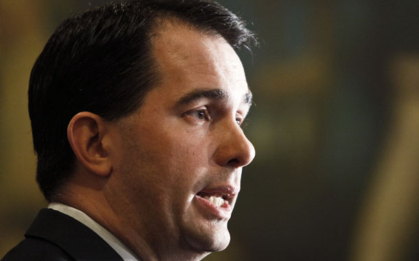 Gov. Scott Walker (R-WI) talks to the media at the State Capitol in Madison, Wisconsin. In March of last year, he signed an antiunion bill that stripped public-sector workers of collective bargaining rights. (AP/Andy Manis)