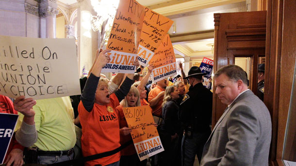 Protestors outside the Indiana House of Representatives during the debate on a right-to-work law that ultimately passed.  (AP/ Darron Cummings)