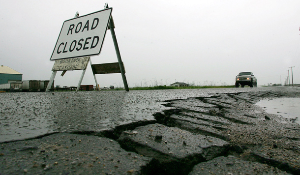 Potholes and road closure are visible at the corner of Enterprise and Paige Avenues in Tulare, California. (AP/Gary Kazanjian)