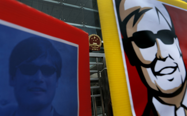 Two images featuring blind Chinese activist Chen Guangcheng are seen during a protest in front of the Chinese central government's liaison in Hong Kong, Friday, May 4, 2012. (AP/Vincent Yu)