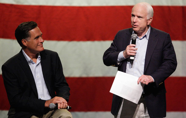 Sen. John McCain (R-AZ), right, talks to supporters as he is joined by former Massachusetts Gov. Mitt Romney during a 2010 town hall meeting in Mesa, Arizona. (AP/Ross D. Franklin)