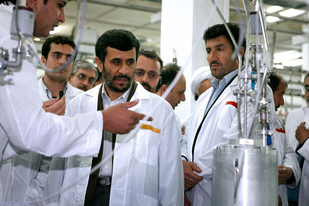 Iranian President Mahmoud Ahmadinejad, center, listens to a technician during his visit of the Natanz Uranium Enrichment Facility in 2008. (AP/ Iranian Presidents office)
