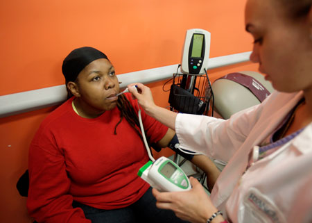 Kamia Funchess has her vitals checked by Taisha Romero at the William F. Ryan Community Health Center in New York.