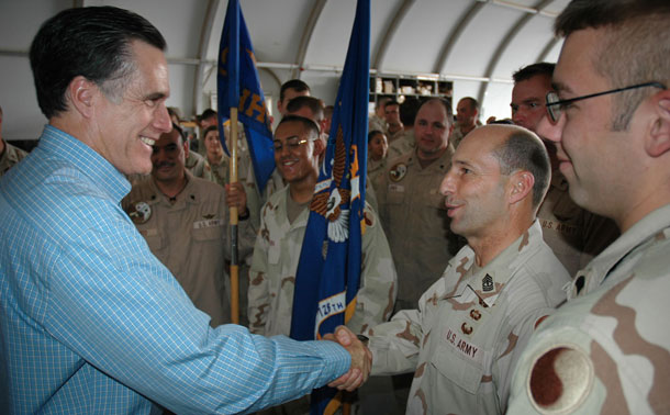 Gov. Mitt Romney meets in May 2006 with Massachusetts Army National Guard members assigned to Aviation Task Force in Camp Buehring, Kuwait, before visiting Iraq. Gov. Romney and President Obama have put forth different foreign policy proposals.<br /> (AP/United States Air Force, Lt. Col. Martin Moerschell)
