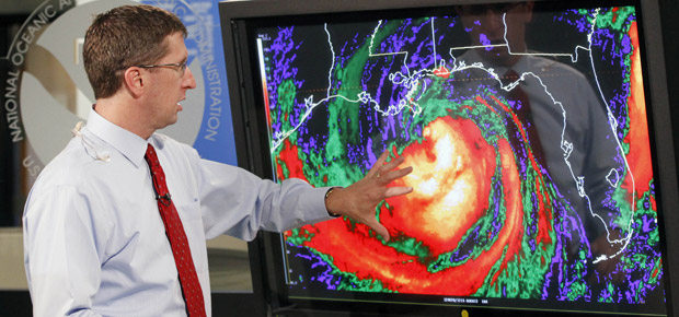 Dr. Rick Knabb, director of the National Hurricane Center, left, gives an update on Hurricane Isaac at the National Hurricane Center in Miami on August 28, 2012. Automatic federal budget cuts from last year's debt limit deal could reduce staffing at the National Hurricane Center and the National Weather Service. (AP/Alan Diaz)