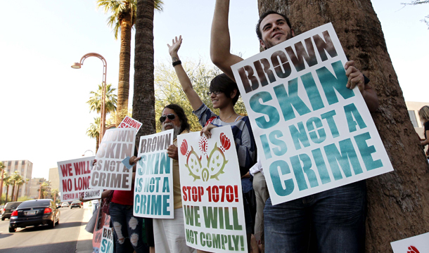 Immigration rights protesters gather near the U.S. Immigration and Customs Enforcement offices in Phoenix, Arizona, after the Supreme Court decision regarding Arizona's anti-immigrant law, S.B. 1070, Monday, June 25, 2012. (AP/Ross D. Franklin)