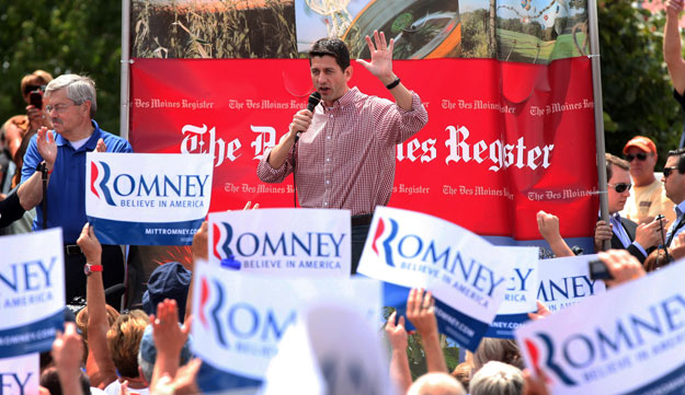 Republican vice presidential candidate Rep. Paul Ryan (R-WI), accompanied by Iowa Gov. Terry Branstad, left, speaks at the Iowa State Fair in Des Moines. The real cost of a Romney-Ryan presidency for Iowans would be steep, especially for seniors, students, and the middle class, among others. (AP/Conrad Schmidt)