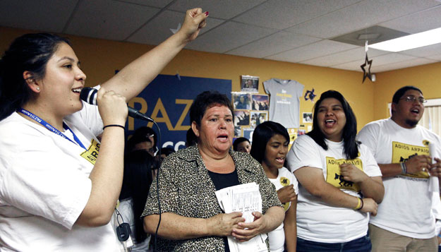 Grecia Lima, left, cheers as Maria Durand, second from left, brings her early voting ballot and joins members of Promise Arizona in Action in announcing their voter registration drive with Latino youth. Latinos overwhelmingly voted for President Obama's re-election last week. (AP/Ross D. Franklin)