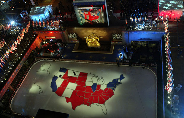Workers walk on a giant presidential election map of the United States made of ice in the skating rink at Rockefeller Center, Tuesday, November 2, 2004, in New York. (AP/Kathy Willens)