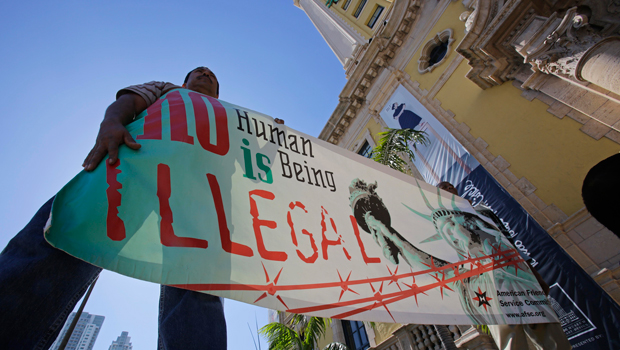 Immigration reform activists hold a sign in front of Freedom Tower in downtown Miami, Monday, January 28, 2013. (AP/Alan Diaz)
