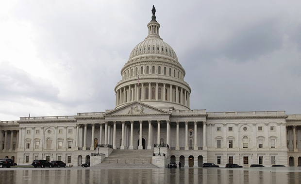 The U.S. Capitol Building is reflected in the Capitol Reflecting Pool on Capitol Hill in Washington. (AP/Carolyn Kaster)