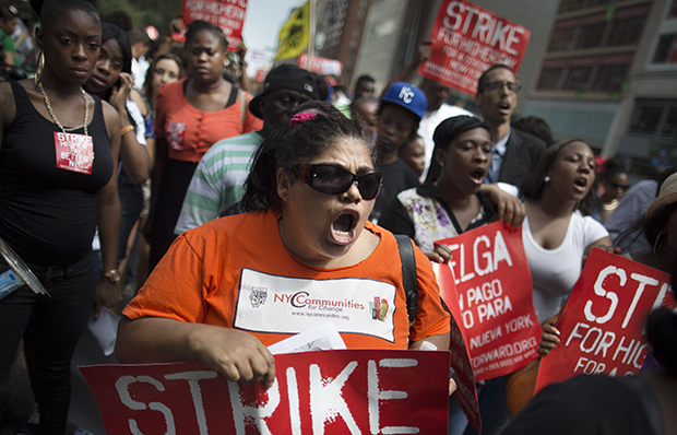 Demonstrators in support of fast-food workers march toward a McDonald's, Monday, July 29, 2013, in New York's Union Square. They are demanding higher wages and the right to form a union without retaliation. (AP/John Minchillo)