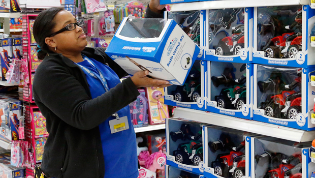An employee stocks shelves for Black Friday sales at a Walmart store in Oklahoma City on November 26, 2013. (AP/Sue Ogrocki)