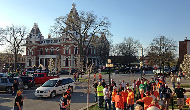 An overflow crowd of union members protest outside a Livingston County board meeting site in Pontiac, Illinois, April 16, 2015. The board was set to consider the governor's right-to-work efforts. (AP/Sara Burnett)