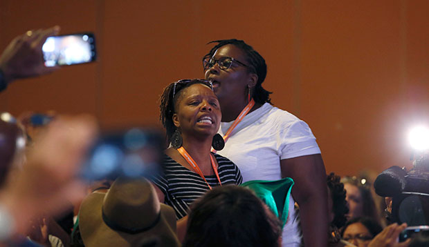 #BlackLivesMatter and Black Immigration Network activists shout down the first of two Democratic presidential candidates at a Netroots Nation town hall meeting, July 18, 2015, in Phoenix. (AP/Ross D. Franklin)