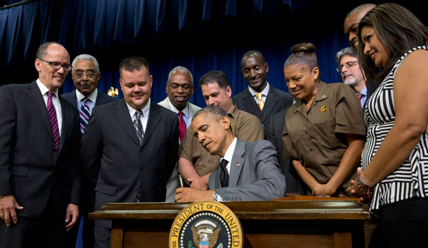 President Barack Obama signs the Fair Pay and Safe Workplaces Executive Order on July 31, 2014. (AP/Jacquelyn Martin)