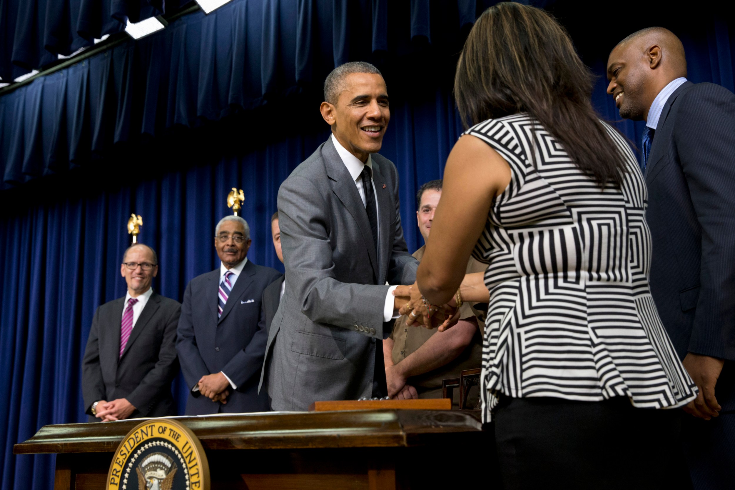 President Barack Obama shakes hands with workers and advocates after signing the Fair Pay and Safe Workplaces executive order on July 31, 2014. (AP/Jacquelyn Martin)