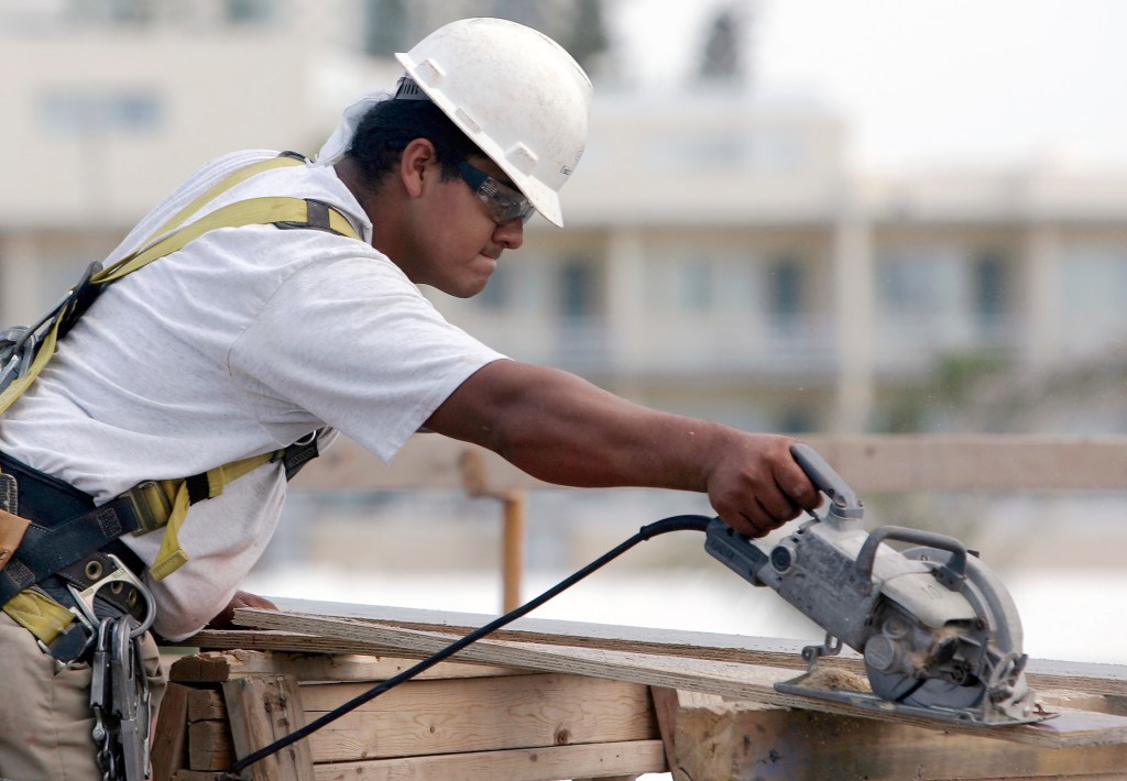 Construction worker Juan Garcia of Mexico works at a construction site Tuesday, May 2, 2006 in Sunny Isles, Fla. Garcia stayed away from work on Monday in support of the immigration rally. Immigrants didn't paralyze commerce or businesses, but Florida still felt their absence as thousands stayed away from work, schools and stores in an effort to show their sizeable role in the U.S. economy. (AP Photo/Alan Diaz)