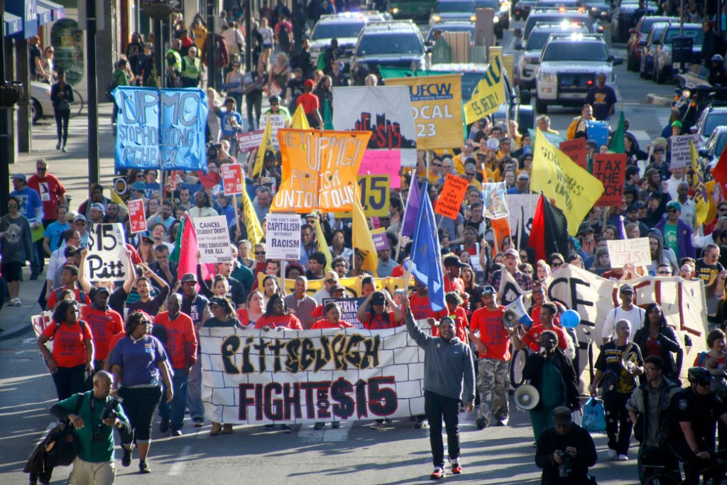 Union organizers, students, and supporters for a $15-an-hour minimum wage march through the Oakland section Pittsburgh on Thursday, April 14, 2016. ((AP/Keith Srakocic))