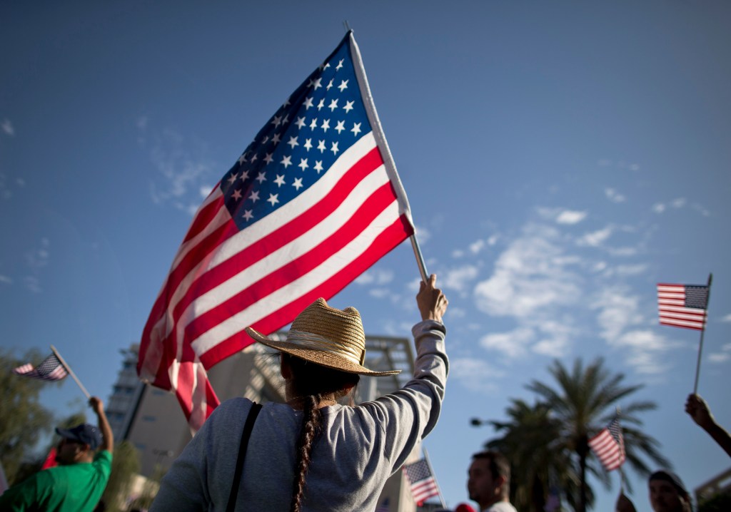A demonstrator waves a flag during an immigration rally on May 1, 2013, in Las Vegas. (AP/Julie Jacobson)