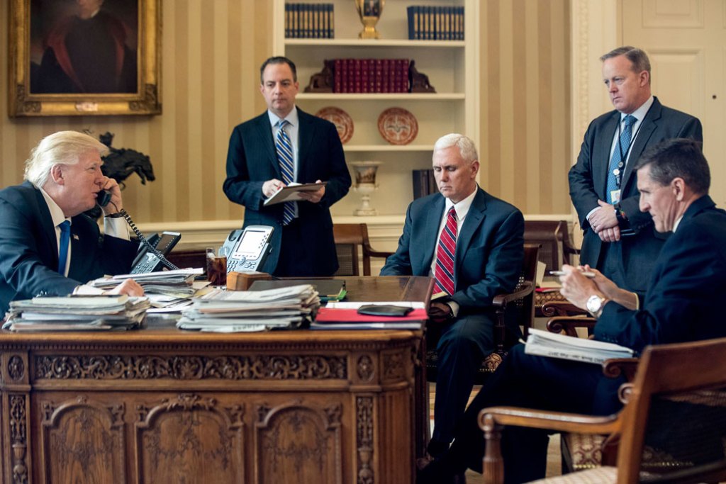 President Donald Trump—accompanied by, from the left, Chief of Staff Reince Priebus, Vice President Mike Pence, White House press secretary Sean Spicer, and National Security Adviser Michael Flynn—speaks on the phone with Russian President Vladimir Putin on January 28, 2017, in the Oval Office. (AP/Andrew Harnik)