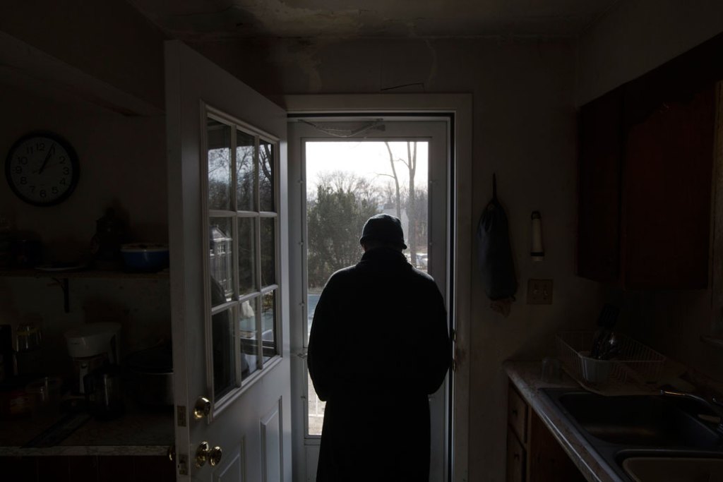 A man looks out into his backyard in Hamilton, Ohio, on January 6, 2016. (AP/John Minchillo)