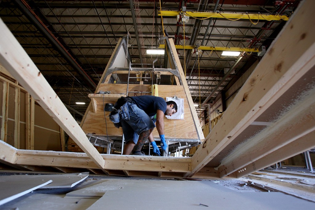 A carpenter frames a wall at the Westchester Modular Homes factory in Wingdale, New York, August 2008.