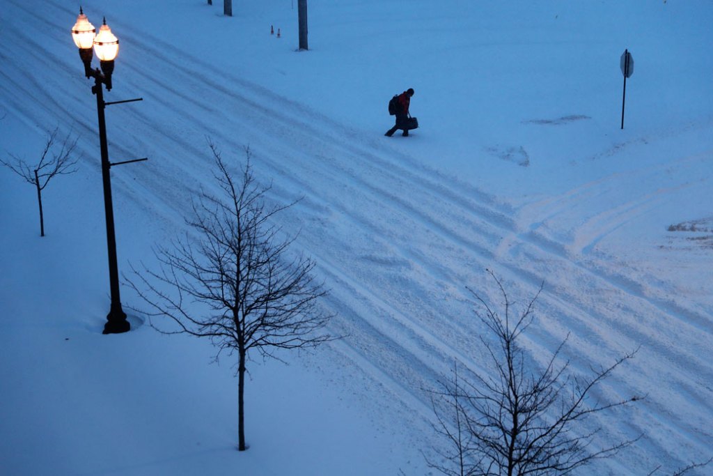 A pedestrian walks down a snow-filled street in Lewiston, Maine, on March 14, 2017. (AP/David Goldman)