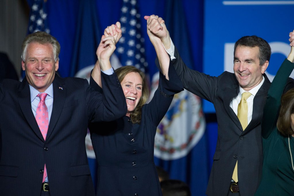 CAPTION: Virginia Gov.-elect Ralph Northam (D) celebrates his election victory with Virginia Gov. Terry McAuliffe and his wife Dorothy. (AP /Cliff Owen)