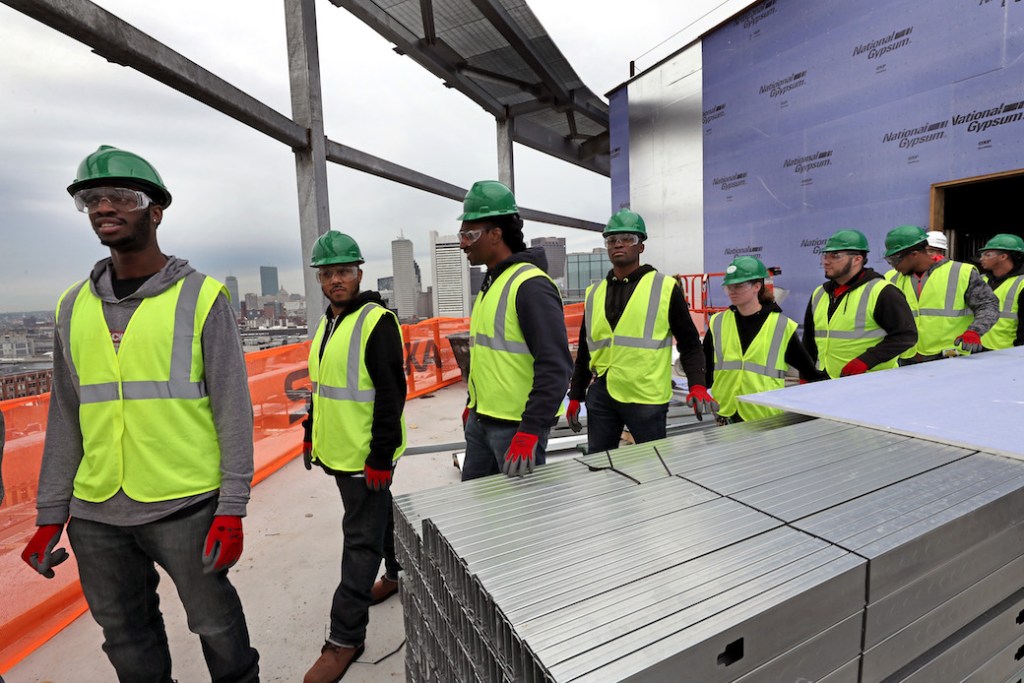 BOSTON, MA - MAY 24: Building Pathways, an organization that creates opportunities for low-income area residents to access and prepare for building trades in the construction industry, tours Skanskas 121 Seaport construction site in Boston on May 24, 2017. The program is 6 weeks and many of them will graduate and pursue union jobs. The day's class had about 10 students ages 19  57. (Photo by David L. Ryan/The Boston Globe via Getty Images) (Getty Images)