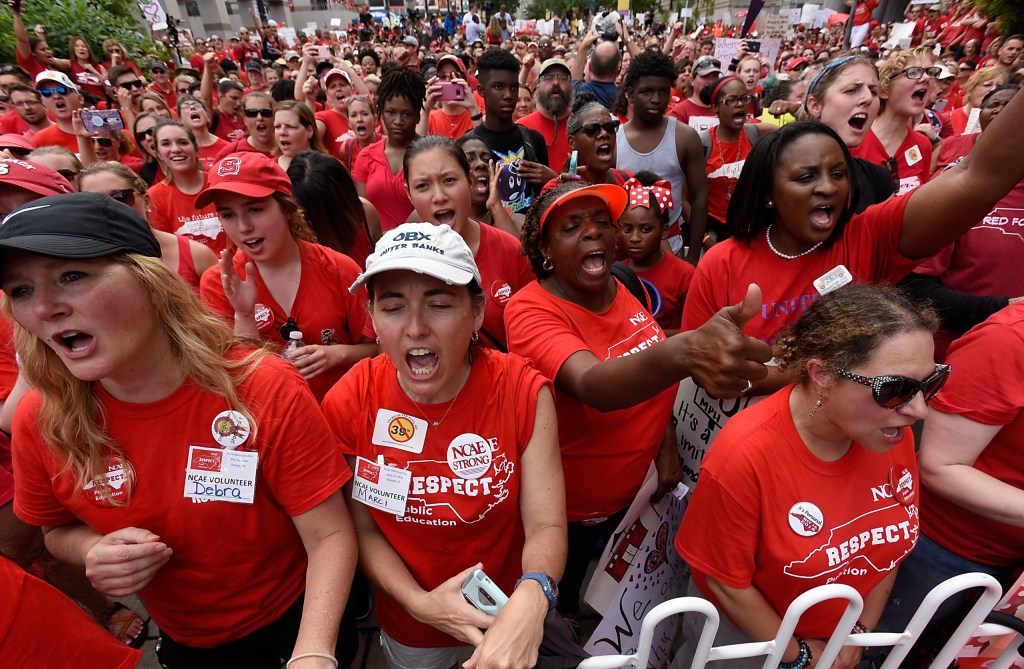 RALEIGH, NC - MAY 16: Crowds cheer during the Rally for Respect outside the North Carolina Legislative Building on May 16, 2018 in Raleigh, North Carolina. Several North Carolina counties closed schools to allow teachers to march on the opening day of the General Assembly.  (Photo by Sara D. Davis/Getty Images)